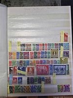 Album page with rows of German stamps, small denomination definitives and commemoratives, catalog numbers on yellow slips