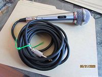 Microphone with coiled cable on folder