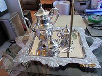 Full tea set on ornate tray with candle holder