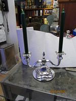 full view of silver-plated two-arm candelabra with candles