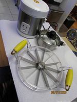 overall lot showing rice cooker base, stainless pot with lid, pineapple cutter