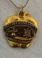 Close-up of pendant showing event text and logos