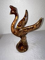 Front view of ceramic swan figurine standing on pedestal