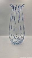 Full front view of clear vase with blue speckles