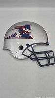 Full view of silver helmet wall hanging with logo and facemask