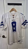 Full front view of white Dallas Cowboys number 8 jersey on hanger