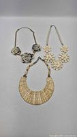 Overview of all three floral necklaces laid flat