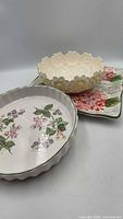 Three serving pieces—tart dish, scalloped bowl, square platter—group overview