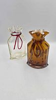 Both art glass gift bag vases front view