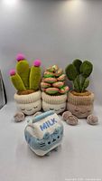 Group shot of three succulent plushes and Pusheen milk plush
