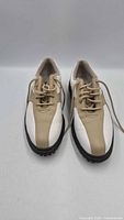 Top view of both shoes showing white and tan leather uppers and laces