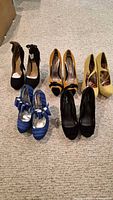 All five pairs of high heel shoes on carpet