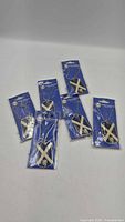 Six packaged Scottish flag dog-tag necklaces displayed