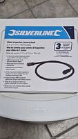 Front of boxed Silverline video inspection camera head showing product name, cable length 1 m, diameter 18 mm, new condition