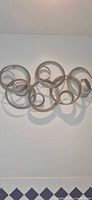 Full view of metal spiral wall art mounted on wall