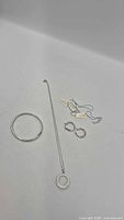 Overview of bracelet, necklace with tags, and earrings