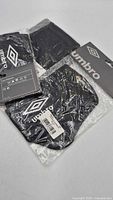 Umbro headbands in original packaging showing black units with tags