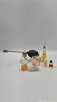 Full group: atomizer, five miniature bottles, solid perfume compact
