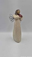 Front view of Willow Tree Angel of the Heart figurine showing overall form, heart, and wings