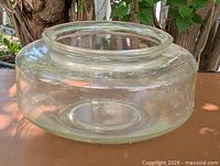 Angled view of entire clear glass fishbowl showing shape and condition