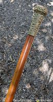 Full length view of swagger stick showing wood shaft and metal cap