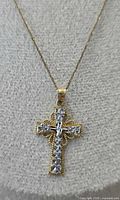 Cross pendant and chain displayed on bust