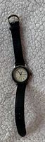 Front view showing dial, bezel, and leather strap