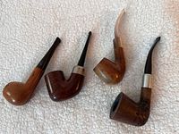 Four pipes laid out showing overall shapes, colors and bands
