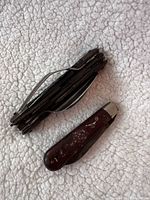 Camping utensil set folded beside pocket knife