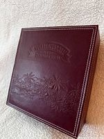 Closed burgundy Appleton Estate presentation box showing embossed logo and stitching