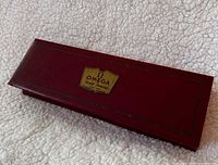 Closed red Omega presentation box