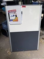 Large whiteboard with small board attached in packaging