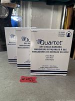 Front view of the three sealed Quartet dry-erase marker boxes
