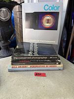 Stack of six photography books with one angled for title visibility