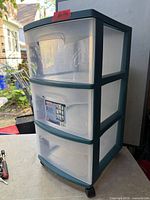 Full view of Sterilite 3-drawer cart on tabletop showing translucent drawers, teal frame, casters visible
