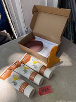 Entire drywall repair kit laid out: three tubes, spreader, sanding discs, mesh patch in box