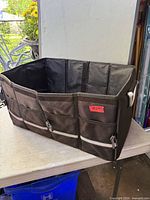 Organizer opened showing interior compartment and exterior pockets