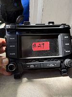 Front view of Hyundai Sonata 5" touchscreen head unit showing buttons and screen