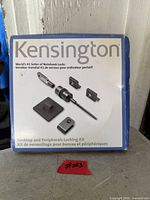 Front of sealed retail box showing Kensington desktop and peripherals locking kit