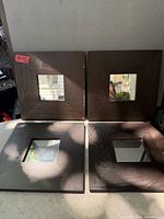 Four identical dark wood square frames with central mirrors displayed together