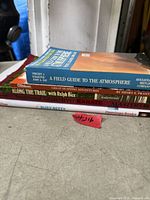Stack of five assorted books showing titles and general wear