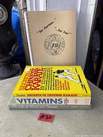 Stack of four books showing covers and spiral booklet