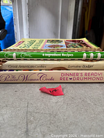 Stack of three cookbooks showing titles and bindings