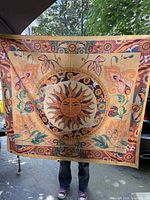 Full view of printed fabric showing sun motif and decorative borders