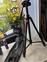 Full view of Vivitar tripod standing with carry bag on floor