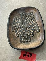 Top view of wooden dish showing carved Haida eagle design