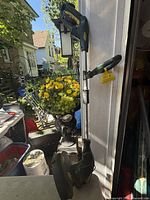 Full view of Yardworks string trimmer leaning against doorway