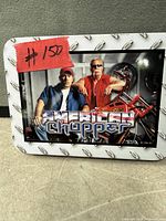 Lid of American Chopper tin showing logo and graphic