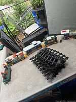 Entire train set layout with cars, accessory, and stacked curved track