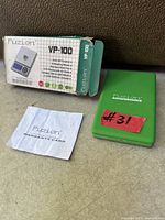 Scale, box and warranty card grouped